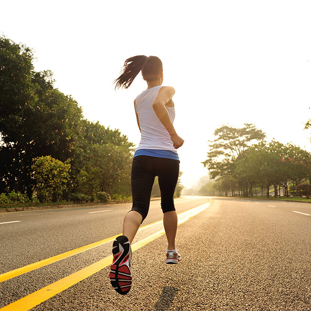 Runner athlete running at road.